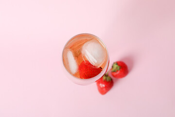 Glass with Rossini cocktail on pink background
