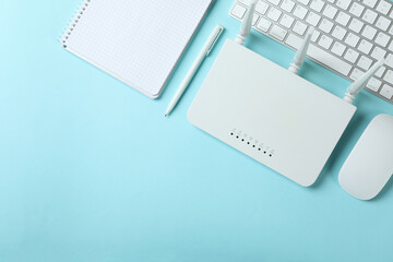 Workplace with Wi - fi router on blue background