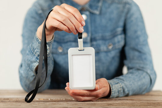 Empty identity badge in hands. Name tag template, security card mockup.