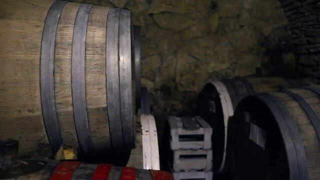 Wooden oak wine barrels. Wine making industry. Storage for bottles and barrels.  Wine or Whiskey in vaults. Barrel in basement. Wine, beer, Whiskey barrels stacked at warehouse. 
