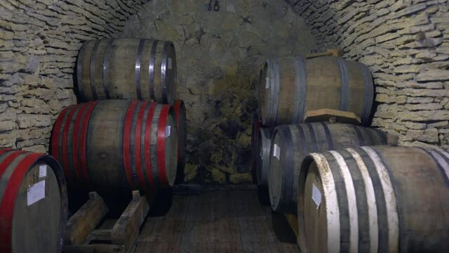 Wooden oak wine barrels. Wine making industry. Storage for bottles and barrels.  Wine or Whiskey in vaults. Barrel in basement. Wine, beer, Whiskey barrels stacked at warehouse. 