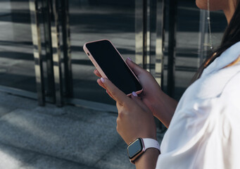 Portrait of a Successful Business woman Using iPhone 12 pro with coffee cup