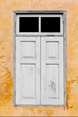 Old white vintage wooden windows and old yellow-brown cement wall