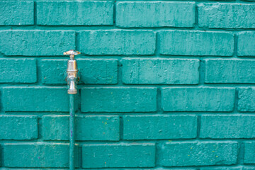 Close up shot of tap mounted against wall