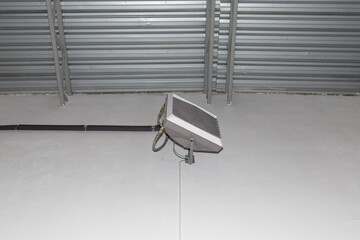 Industrial heater, hanging on the wall of the hall, used for air heating and for cooling with cold...