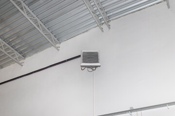 Industrial heater, hanging on the wall of the hall, used for air heating and for cooling with cold...