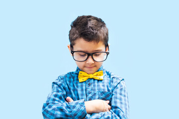 shy boy with glasses on a blue background.