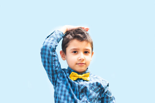 little boy shows his height. Portrait of a boy on a blue background
