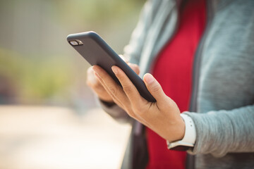 Asian woman using smartphone at city