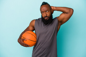 African american man playing basketball isolated on blue background touching back of head, thinking and making a choice.