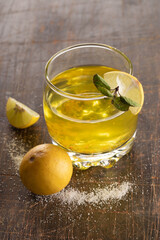 Lemonade drink surrounded by its ingrediens - Lemons, Salt and mint leaves