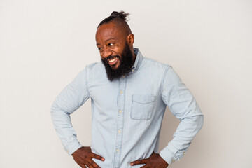 African american man with beard isolated on pink background laughs happily and has fun keeping...