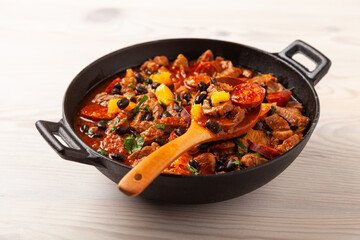 Pork stew with chorizo and black beans. Served with orange and seasoned with hot chili peppers. Perfect with tortillas.