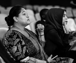 Two International Business Women Sitting in a COnference Room