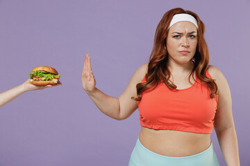 Young chubby overweight plus size big fat fit woman in red top warm up training do stop palm hand...