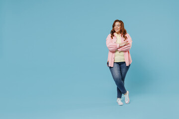 Full length young fun smiling redhead chubby overweight woman 30s wearing in pink shirt jeans...