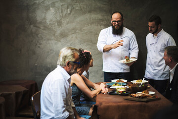 Chef explaining a dish to a customer