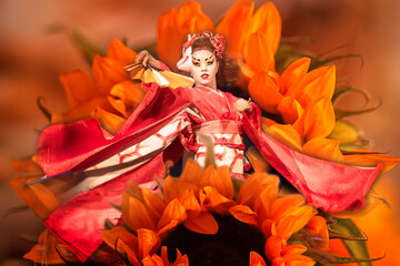 Japanese woman dances with a fan. Collage with flowers. Traditional Japanese performance, red fox dance. Kino Kitsune fox is a character in Japanese legends.