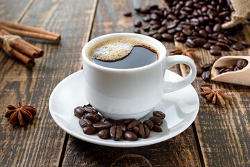 Cup of coffee on a wooden table. The concept of making natural coffee from quality coffee beans.