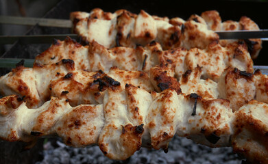 Cooking meat on the grill, barbecue, pieces of meat planted on a skewer. Roasting kebab on coals
