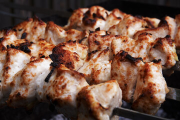 Cooking meat on the grill, barbecue, pieces of meat planted on a skewer. Roasting kebab on coals