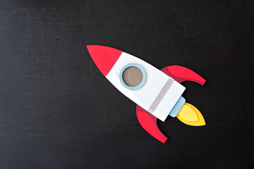 Rocket spaceship paper craft on a black background