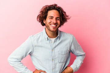 Young caucasian man isolated on pink bakcground happy, smiling and cheerful.