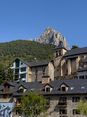 Fototapeta na wymiar Sallent de Gállego church and Foratata peak, Tena valley, Huesca province, Aragon, Spain