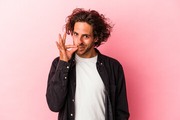 Young caucasian man isolated on pink bakcground with fingers on lips keeping a secret.