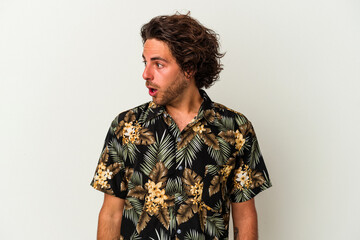 Young caucasian man isolated on white background being shocked because of something she has seen.