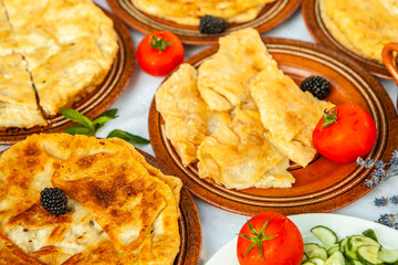 Traditional fried pies from Romania with potatoes, cheese and cabbage. Romanian food.