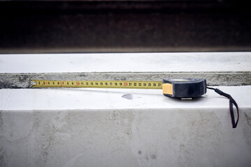 Measuring tape tool on a contruction site.