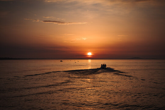 Sunrise on the medditerranean sea with a boat Valras France. Beautiful orange sky
