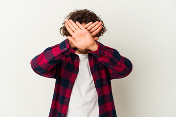 Young caucasian man isolated on white background keeping two arms crossed, denial concept.