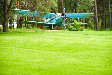 A plane on a green lawn. Green lawn. field.