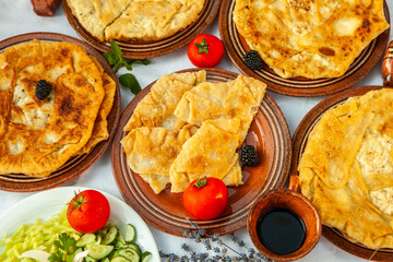 Traditional fried pies from Romania with potatoes, cheese and cabbage. Romanian food.