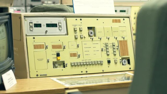 Military base bunker. Nuclear warhead control panel. Panel with sensors and buttons to launch a missile to destroy the enemy in wartime. There is a TV on the side, a chair in the foreground