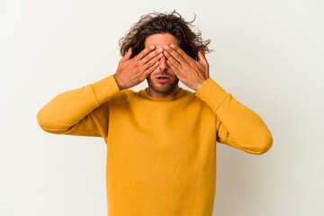 Young caucasian man isolated on white background afraid covering eyes with hands.