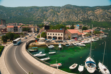 White boats and old buildings in the waterfront of the old city center of Kotor by the Adriatic sea of Montenegro with white 