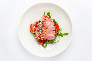 tuna fillet with salad on white plate