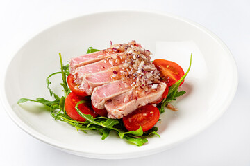 tuna fillet with salad on white plate