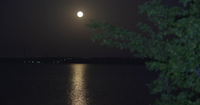 View of river and full moon at night