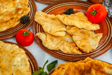 Traditional fried pies from Romania with potatoes, cheese and cabbage. Romanian food.