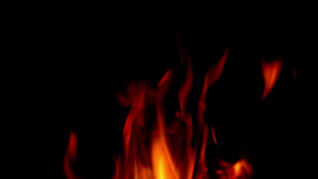 Warm cozy fire in fireplace. Flying embers from fire.