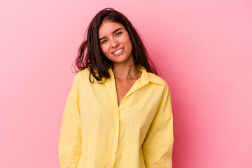 Fototapeta premium Young caucasian woman isolated on pink background laughs and closes eyes, feels relaxed and happy.