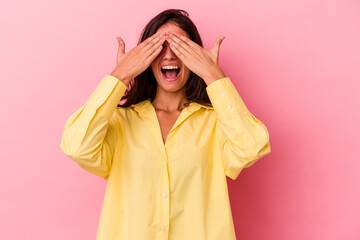 Young caucasian woman isolated on pink background covers eyes with hands, smiles broadly waiting for a surprise.