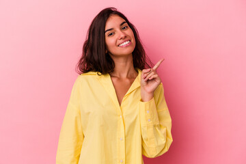 Young caucasian woman isolated on pink background showing number one with finger.