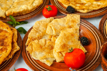 Traditional fried pies from Romania with potatoes, cheese and cabbage. Romanian food.