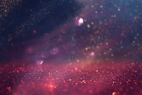 background of abstract gold, pink, purple and black glitter lights. defocused © tomertu