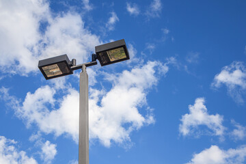 Street lamp, lamp pole on blue sky background